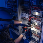 freepicdownloader.com male electrician works switchboard overalls against backdrop emergency lighting normal 1