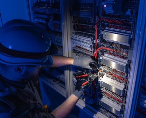 freepicdownloader.com male electrician works switchboard overalls against backdrop emergency lighting normal 1
