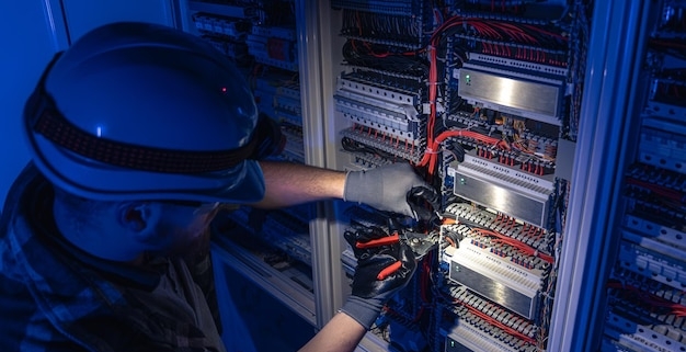 freepicdownloader.com male electrician works switchboard overalls against backdrop emergency lighting normal 1