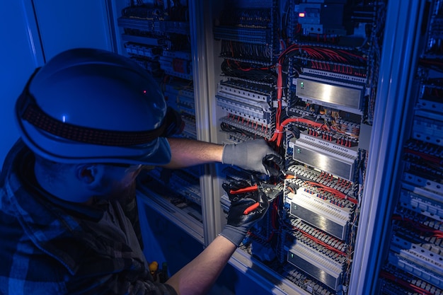 freepicdownloader.com male electrician works switchboard overalls against backdrop emergency lighting normal 1